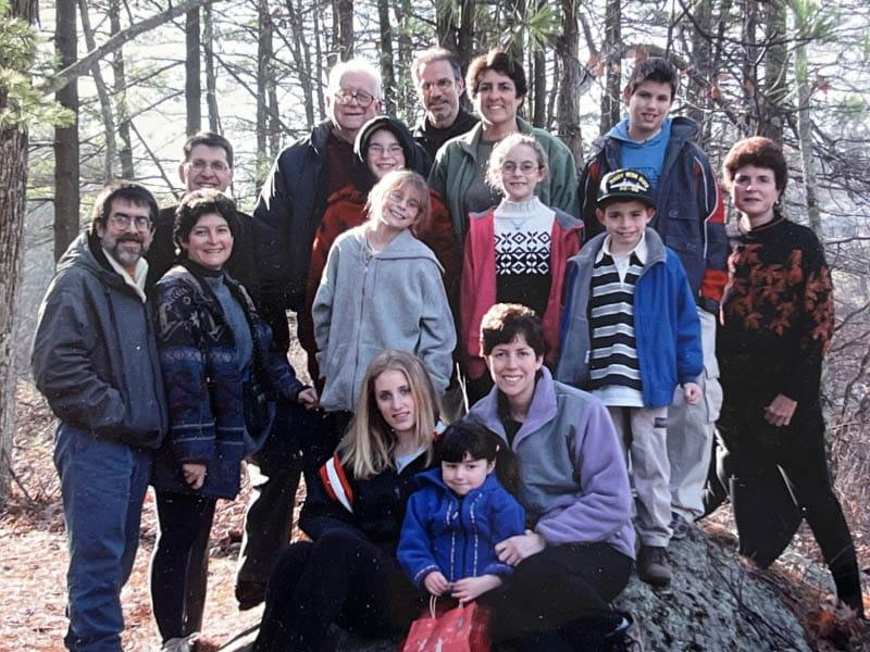 Dr. Eugene Braunwald (back row, right) with his daughters, their spouses and children, and his wife, Elaine (far left), on Thanksgiving Day 2003. (Photo courtesy of the Braunwald family)